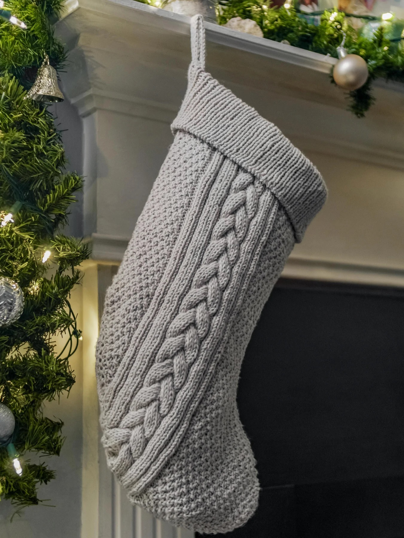 A cable knit Christmas stocking, inspired by the line art trails left when a sled